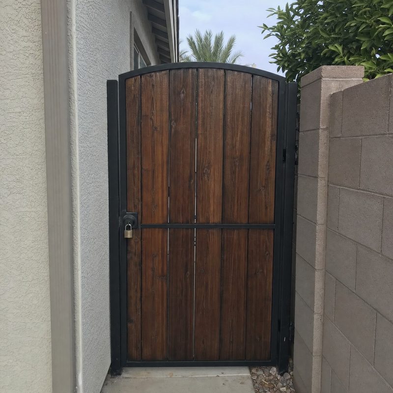 A side gate closed and padlocked.